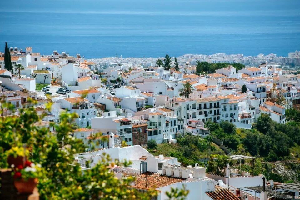 View of Frigiliana, a white town on the Costa del Sol in Andalusia, Spain, with the sea in the background.